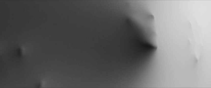 A screaming woman's face and hands appear from the white surface