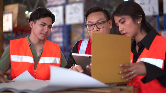 Asian distribution warehouse staffs working.
