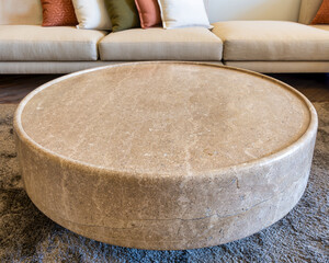 Close-up of marble coffee table with couch in the background in a modern living room. The coffee...