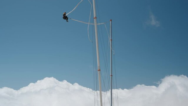 A tourist attraction a Slingshot or Catapult. high in the mountains above the clouds. The daring individual, loving thrills and adrenaline, is on the Tarzan rope and gets catapulted high into the air.