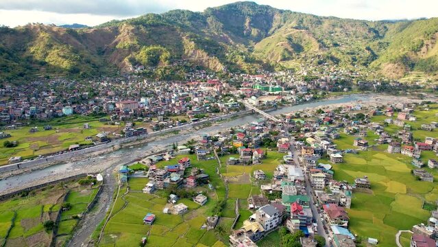 Aerial of the town of Bontoc, the capital of the landlocked province of Mountain Province, in the Cordillera Region of the Philippines. A valley town with terraced rice fields and residential areas.