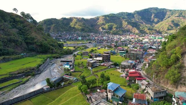 Aerial of the town of Bontoc, the capital of the landlocked province of Mountain Province, in the Cordillera Region of the Philippines. A valley town with terraced rice fields and residential areas.