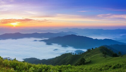 Obraz premium green mountain with fog and sunrise twilight sky at background