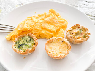 Gourmet Breakfast Delights with Scrambled Eggs and Mini Quiches