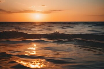 Obraz premium Serene beach sunset with gentle ocean waves, yellow and golden sky, perfect for themes of peace, nature and travel. generative ai