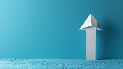 A white arrow made of paper points upward against a serene blue background, visualizing continuous development and motivation in business