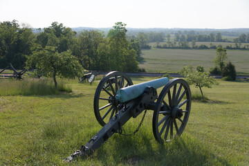 12 pounder bronze smooth bore, Napoleon Model 1857 at Gettysburg National Military Park, Pennsylvania. Battlefield in the background.