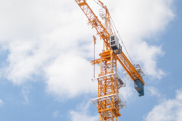 the tower crane stand stability at construction site and close up to shows details of parts.