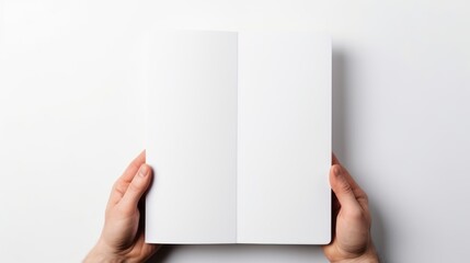 Hands presenting an open book with blank white pages