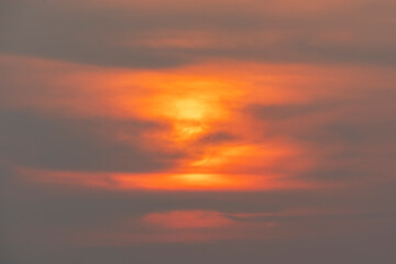 Evening sky time with sun and orange clouds in sunset sky background.Heat wave hot sun, climate change and global warming concept.