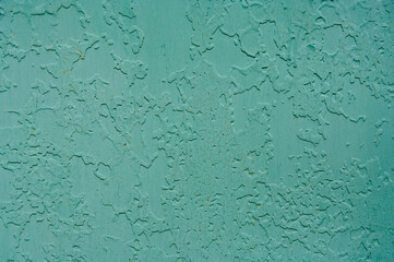 Old paint on metal. Peeling paint on a metal fence. Painted over old paint.