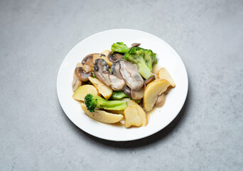 Vegetables and raw oysters on a plate