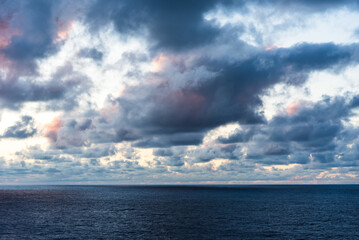 Dramatic sunset sky over the calm ocean. 