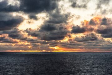 Dramatic sunset sky over the calm ocean. 