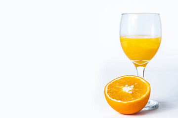 Orange juice in a glass with slices of orange on a white background with space for text. juice in glass