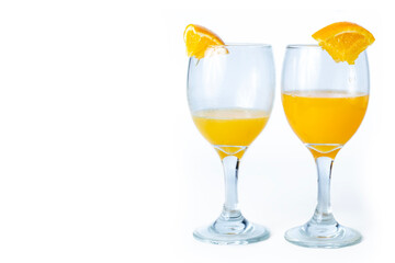 Two glasses of orange juice and orange slice isolated on white background with copy space for your text.