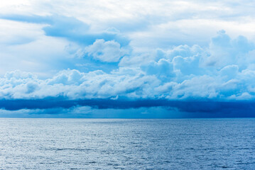 Dramatic sky over the Indian Ocean, rainy clouds almost touching ocean surface. 