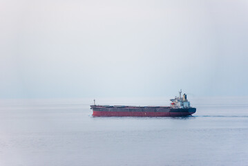 Cargo ship, bulk carrier sailing through the calm sea.