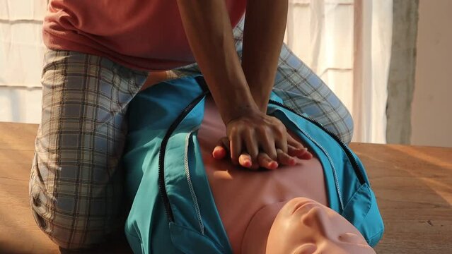 Close-up of CPR on doll's hand (Cardiopulmonary Resuscitation) A resuscitation technique used in emergencies to resuscitate a person who has stopped breathing or whose heart has stopped beating.