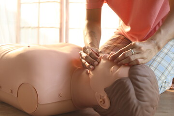 Close-up of CPR on doll's hand (Cardiopulmonary Resuscitation) A resuscitation technique used in...