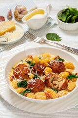 tuscan chicken meatballs with gnocchi in a bowl