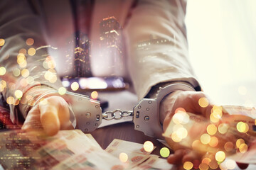 Double exposure of male hands locked in handcuffs city landscape background. Hands in handcuffs...