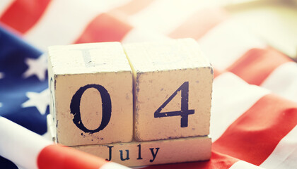 Cube shape calendar for July 04 on wooden table on usa flag background