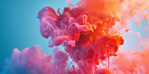 Obraz premium A mixture of various colored inks dispersing and blending in water, creating a vibrant and dynamic background design