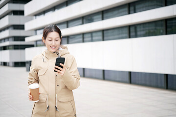 Modern Urban Lifestyle: Woman with Smartphone and Coffee