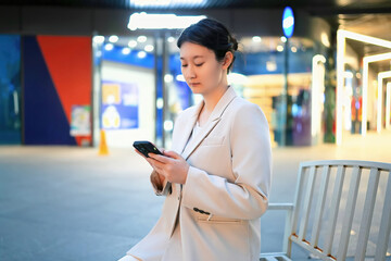 Businesswoman Texting on Smartphone in Urban Setting