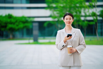 Professional Woman with Smartphone and Coffee on Break