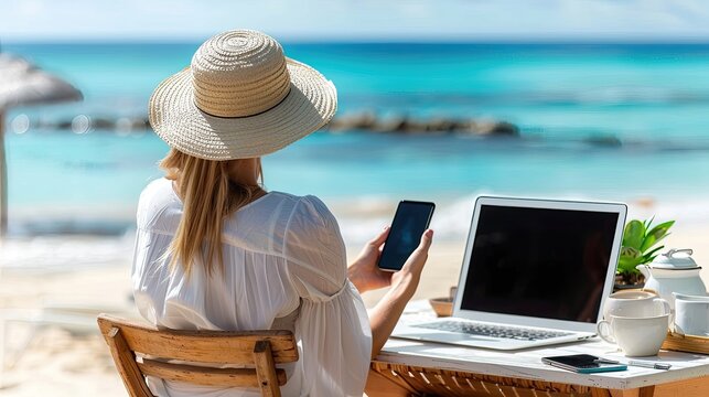 A woman is sitting on a beach chair with a laptop