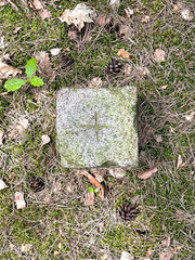 Boundary stone in the forest, granite pillar viewed from above 3:4