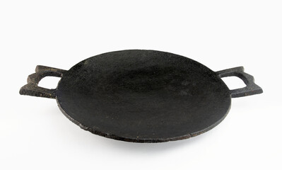 Blank cast iron pan. fish frying on a black pan. an Indian frying pan or griddle used for cooking chapattis.
