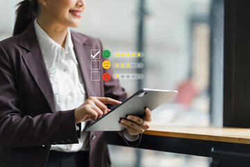 Businesswoman interacting with customer satisfaction feedback icons at her desk