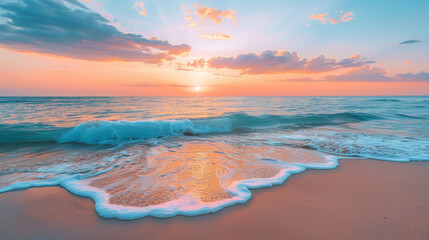 Stunning beach sunset with soft waves washing over golden sand under a beautiful orange sky.