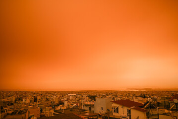 African dust covers the city of Athens in Greece. The color of the sky turned into orange during sunset