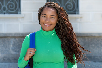 Pretty black female student with dreadlocks and green shirt