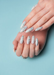 Female hands with blue nail design. Blue nail polish manicure.
