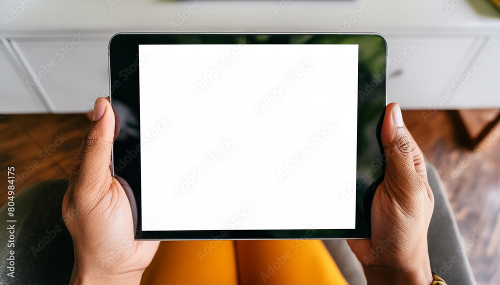 Poster mockup image of a hand holding digital tablet with blank white desktop screen