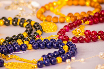 Abstract Art Accessory shooting, gem Nacklace and bracelet with silver, gem colored stone, white texture background, artistic style, photo is selective focus with shallow depth of field. Cairo Egypt