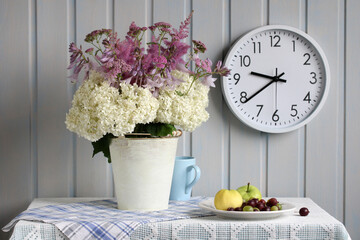 a summer rural still life with a bouquet of hydrangeas and other flowers on the table in the...