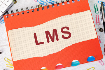 Word cloud concept. LMS - Learning Management System acronym written on a piece of a sheet in a...