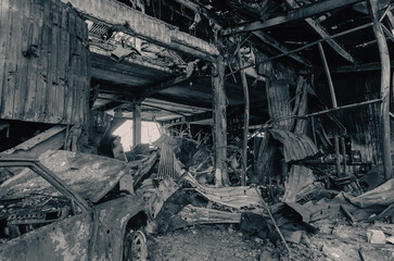 burnt car on the street of the ruined city