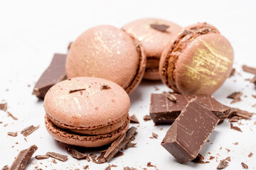 Macaroons with chocolate cream on a light background