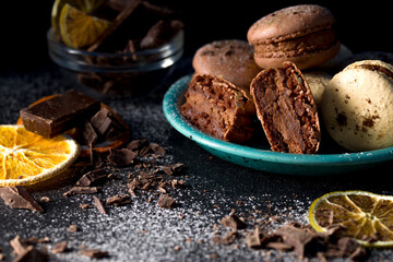 Macaroons with chocolate cream on a dark background