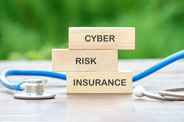 Cyber Risk Insurance text on wooden blocks on a green background - obrazy, fototapety, plakaty