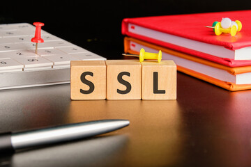SSL - Secure Sockets Layer written on wooden cubes on a black background in a composition with a...