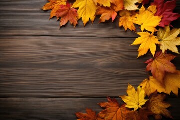 A rustic wooden table with a frame of autumn leaves scattered around it.