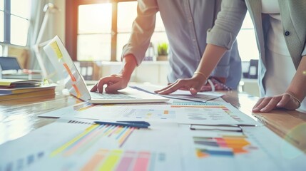Professional team analyzing charts and data on a sunlit desk, ideal for corporate strategy and business analysis themes.